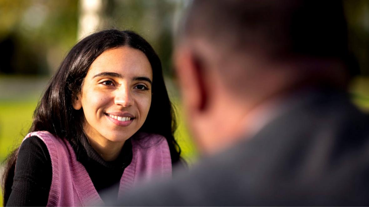 Closeup of a smiling person interacting with another person