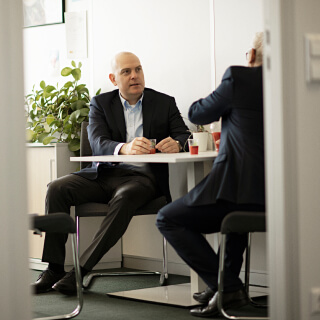 Two people in an office sampling beverages