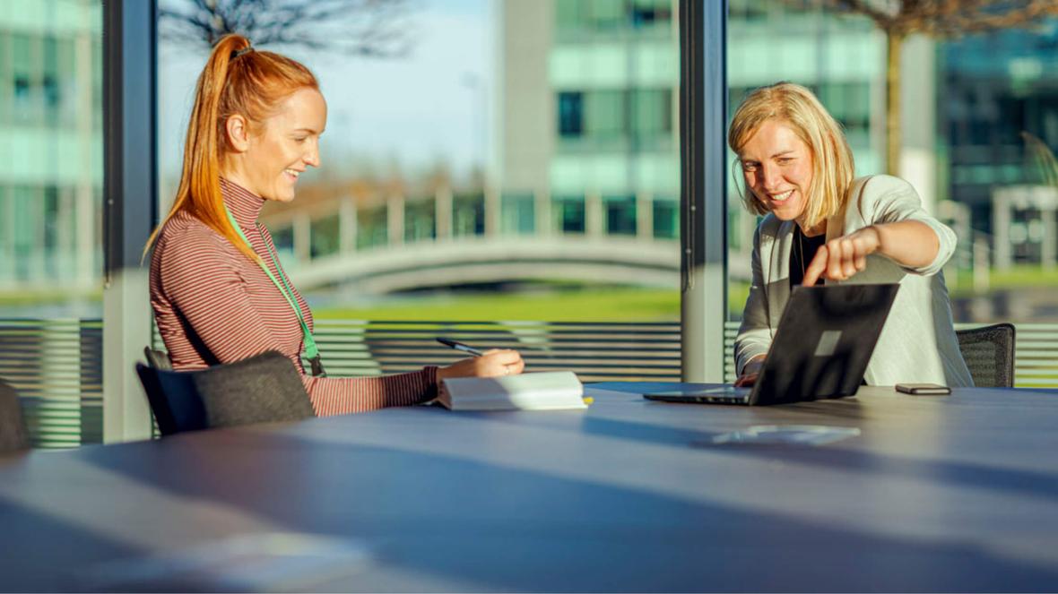 Two people interacting in a conference room