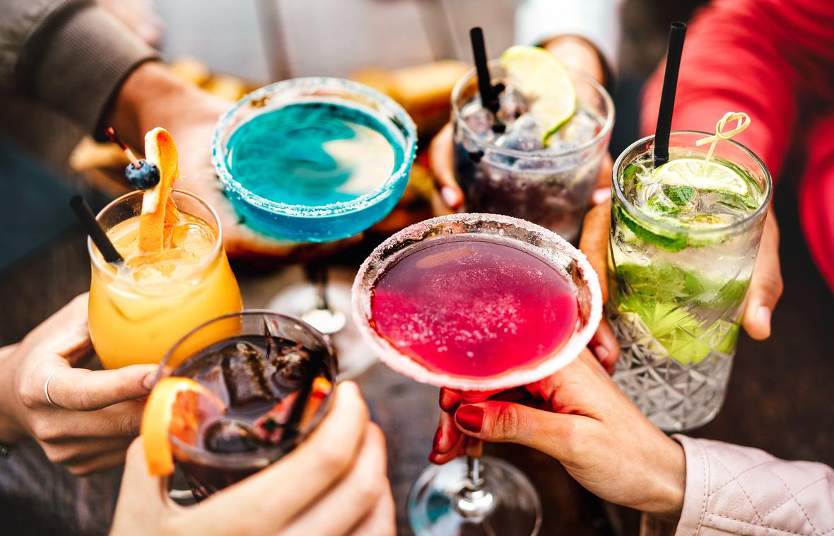 Friends toasting different drinks
