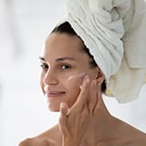 A person applying cream on her face