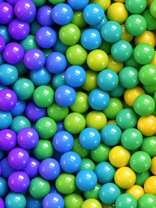 Glossy ball candies in blues, greens, purples, and yellows 
