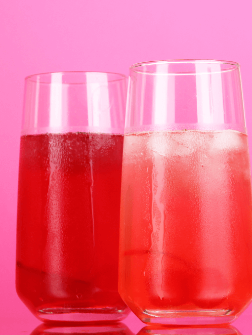 Two glasses of bright red and pink cherry cocktails