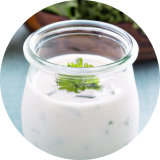 White ranch dressing in a small glass jar 