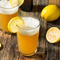 our portfolio hop flavors lemon shandy beer like beverage with lemon wedge