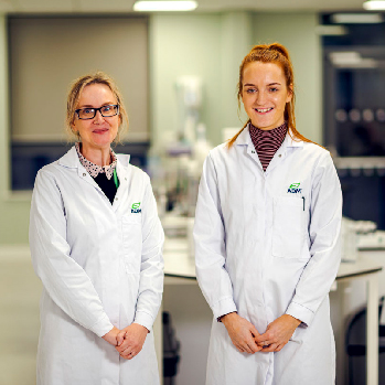 Two ADM scientists stand in a lab