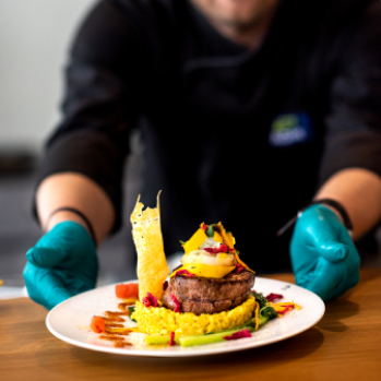 server placing dish of food on table