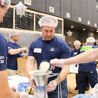 A person pouring a mixture into a container