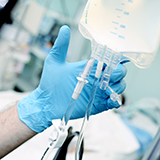 Close-up of a hand holding an IV drip