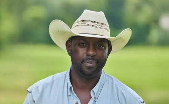 A farmer standing in a field.