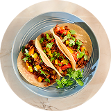 View from above three tacos with colorful vegetables and plant based protein on ceramic plate / Pogled odozgo na tri takosa sa šarenim povrćem i biljnim proteinima na keramičkom tanjiru