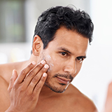 A person applying cream on his face