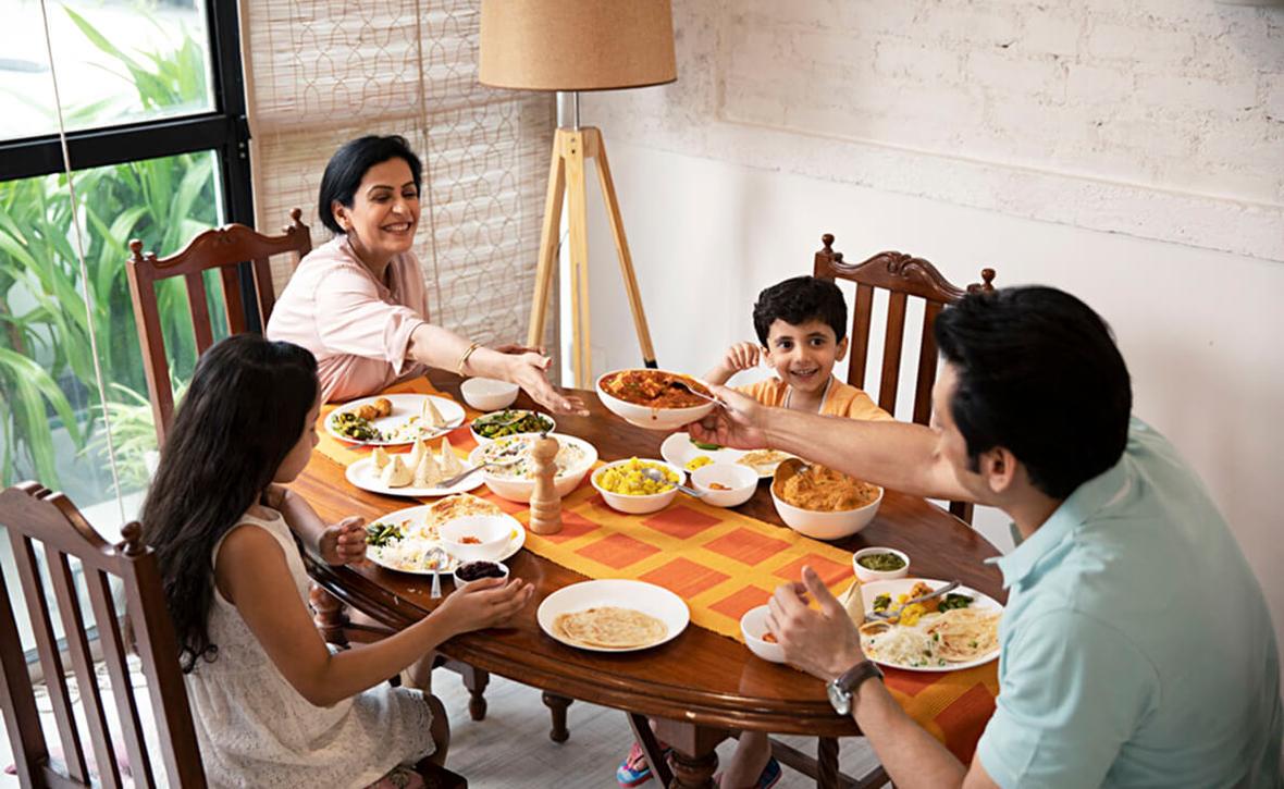 A family sitting at a table with food